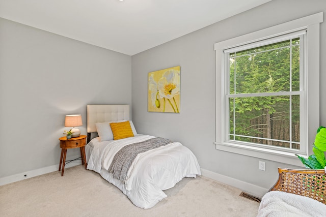 carpeted bedroom with baseboards and visible vents