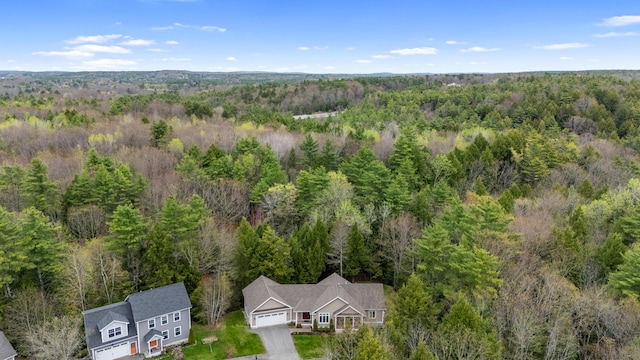 birds eye view of property featuring a view of trees