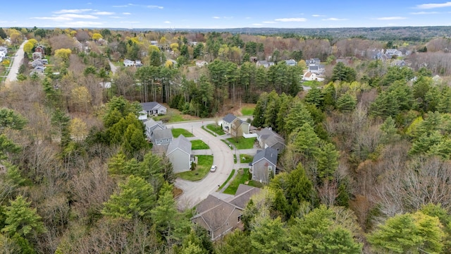 aerial view featuring a residential view and a wooded view