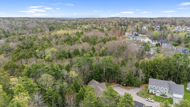 birds eye view of property featuring a wooded view