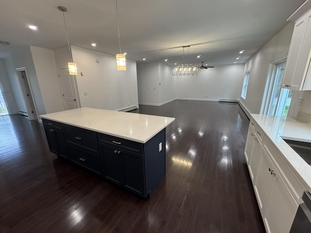 kitchen with open floor plan, dark cabinetry, dark wood-type flooring, plenty of natural light, and recessed lighting