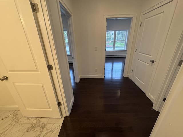 hallway featuring baseboards and baseboard heating