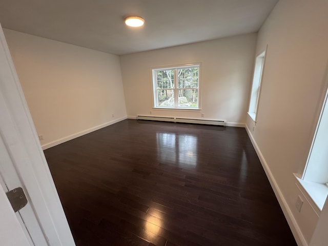 unfurnished room featuring a baseboard radiator, dark wood-style floors, and baseboards