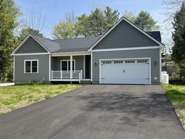 single story home featuring covered porch, asphalt driveway, an attached garage, and a shingled roof