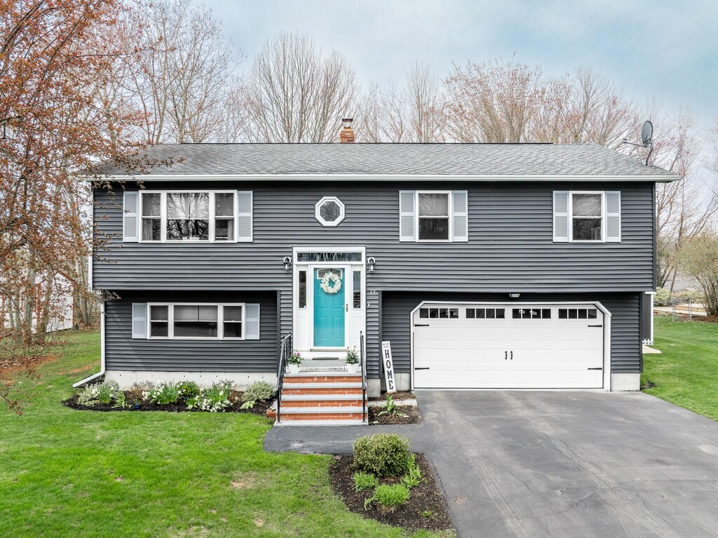 37 Jennifer Ln, Bangor, ME 04401 - raised ranch featuring an attached garage, a front lawn, asphalt driveway, and a chimney