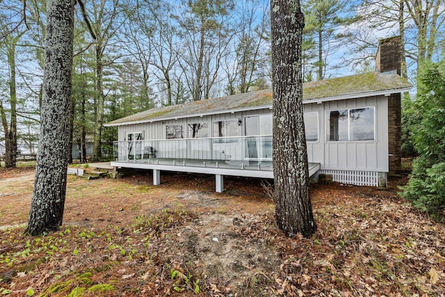 79 Snug Harbor Rd, Standish, ME 04084 - rear view of property featuring a chimney, board and batten siding, a deck, a shingled roof, and crawl space