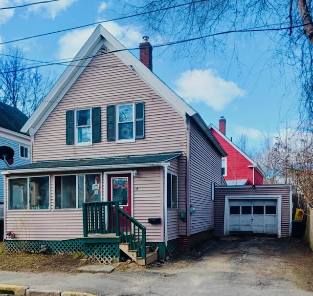 view of front of home with a chimney and driveway