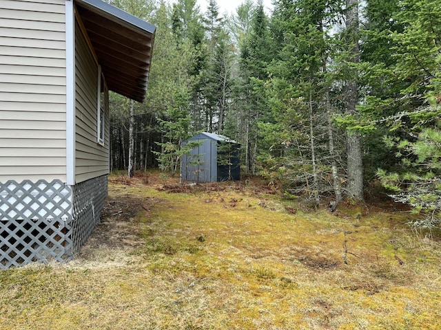 51 Pond Rd, Bradford, ME 04410 - view of yard with a view of trees, a shed, and an outbuilding