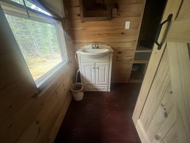 51 Pond Rd, Bradford, ME 04410 - bathroom featuring wooden walls, vanity, and wood finished floors