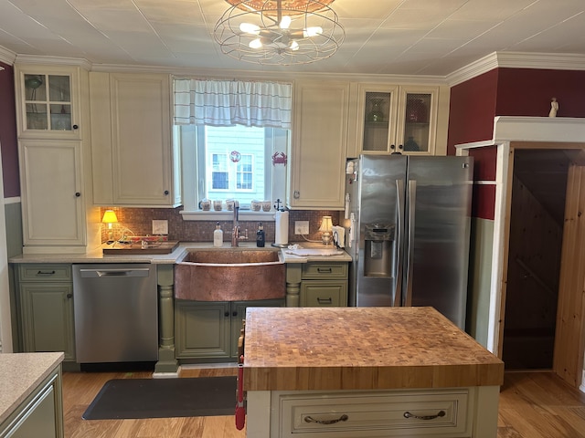 5 Cone St, East Millinocket, ME 04430 - kitchen with stainless steel appliances, a sink, a chandelier, backsplash, and crown molding