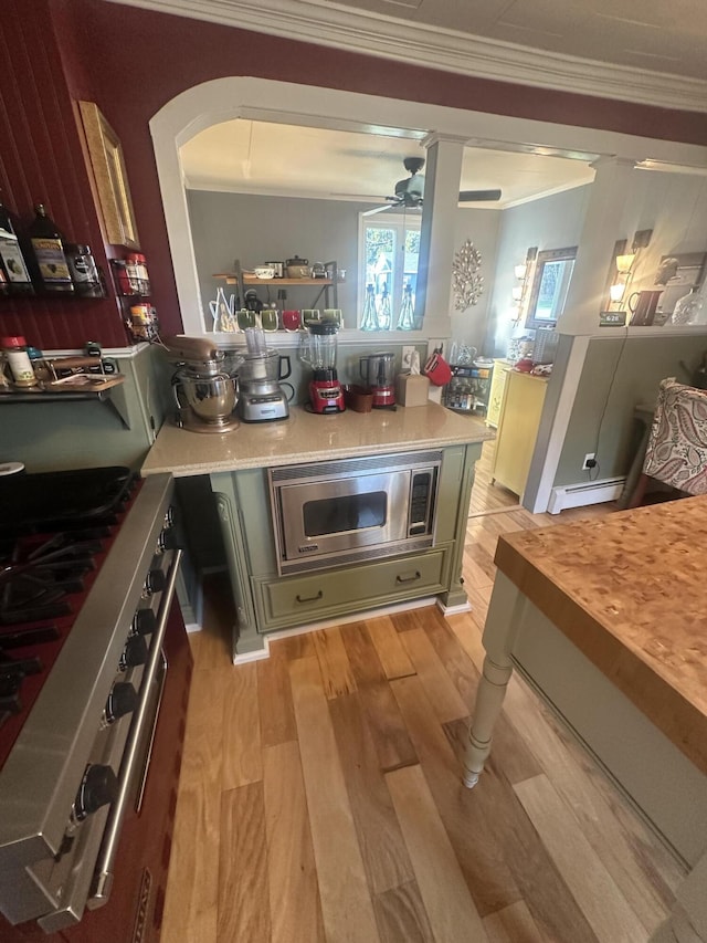 5 Cone St, East Millinocket, ME 04430 - bar with stainless steel microwave, stove, light wood-style flooring, crown molding, and ceiling fan