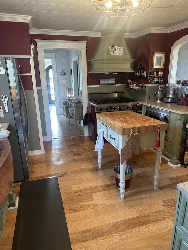 5 Cone St, East Millinocket, ME 04430 - playroom with arched walkways, light wood finished floors, ornamental molding, and a chandelier