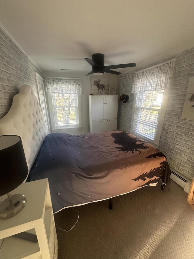5 Cone St, East Millinocket, ME 04430 - carpeted bedroom with brick wall, a baseboard heating unit, and ceiling fan