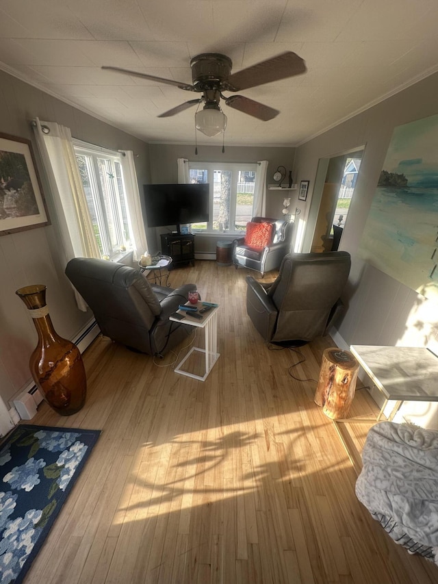 5 Cone St, East Millinocket, ME 04430 - living area featuring a baseboard heating unit, wood finished floors, crown molding, and a ceiling fan