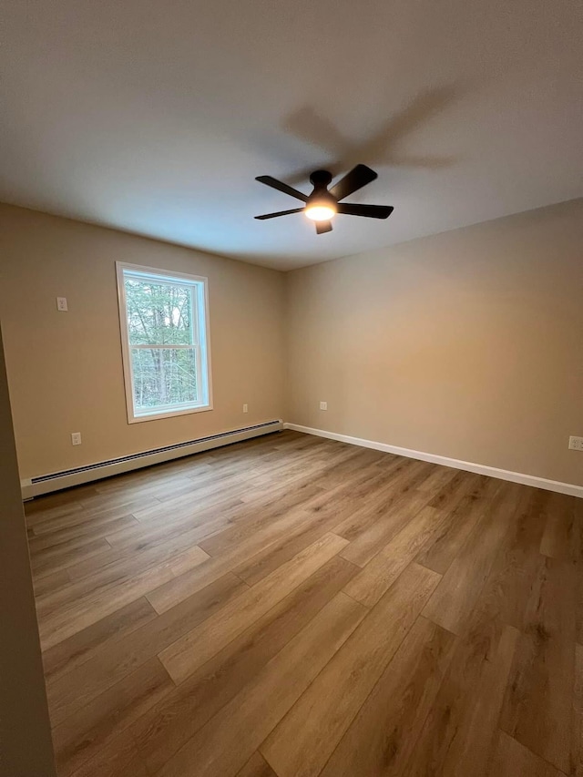 LOT22F Dunton Rd, Naples, ME 04055 - spare room with a baseboard heating unit, wood finished floors, and a ceiling fan