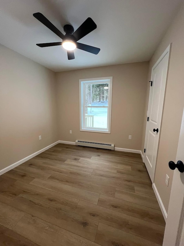 LOT22F Dunton Rd, Naples, ME 04055 - empty room with a baseboard heating unit, wood finished floors, and a ceiling fan