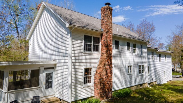 196 Eaton Ridge Dr, Holden, ME 04429 - back of property featuring a chimney, roof with shingles, and entry steps