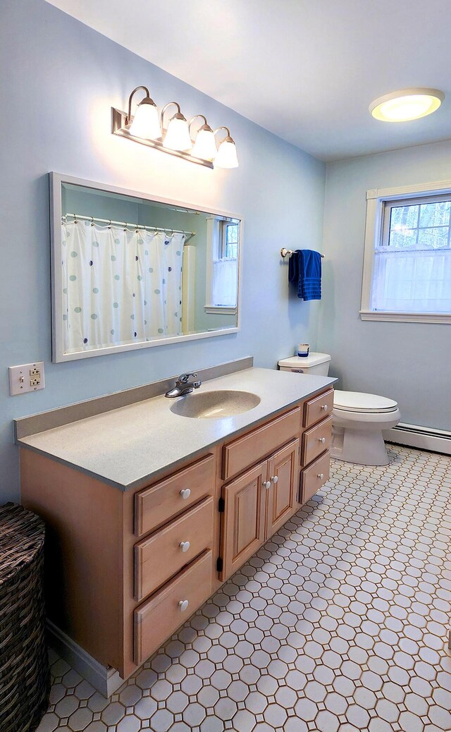 196 Eaton Ridge Dr, Holden, ME 04429 - full bathroom featuring baseboard heating, vanity, and toilet