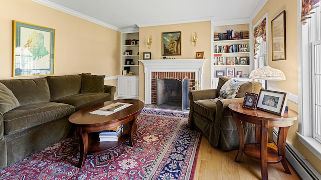 196 Eaton Ridge Dr, Holden, ME 04429 - living room with baseboard heating, wood-type flooring, built in features, crown molding, and a fireplace