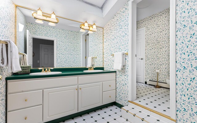196 Eaton Ridge Dr, Holden, ME 04429 - bathroom featuring a baseboard heating unit, wallpapered walls, double vanity, and tile patterned floors