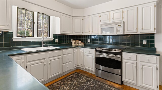 196 Eaton Ridge Dr, Holden, ME 04429 - kitchen featuring stainless steel electric range oven, white microwave, a sink, and white cabinets