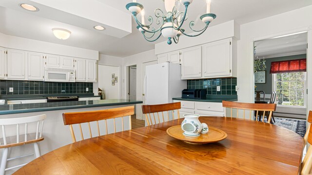 196 Eaton Ridge Dr, Holden, ME 04429 - kitchen with white microwave, dark countertops, white cabinets, backsplash, and recessed lighting
