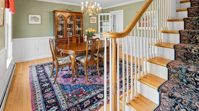 196 Eaton Ridge Dr, Holden, ME 04429 - dining room with baseboard heating, ornamental molding, wood finished floors, a chandelier, and wainscoting