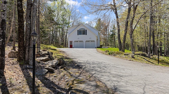 196 Eaton Ridge Dr, Holden, ME 04429 - view of side of home featuring an attached garage and asphalt driveway