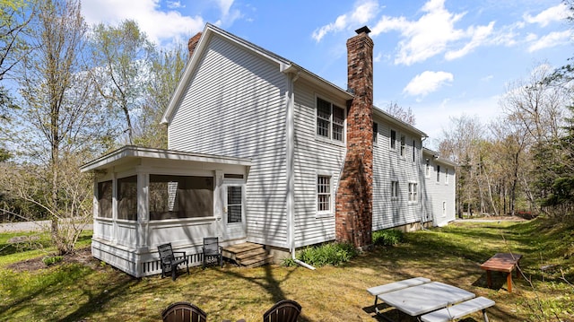 196 Eaton Ridge Dr, Holden, ME 04429 - rear view of property with a chimney, a lawn, and entry steps