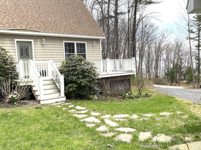 view of grassy yard featuring a deck