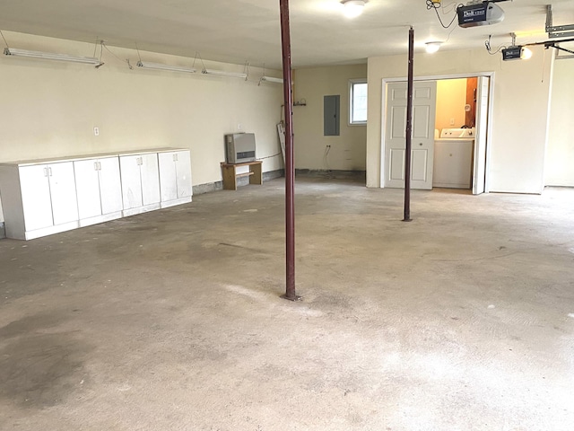 garage featuring a garage door opener, washer / clothes dryer, and electric panel