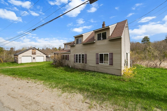 20 Crystal Spring Ln, Rome, ME 04963 - rear view of property with a detached garage, an outbuilding, a chimney, a lawn, and roof with shingles