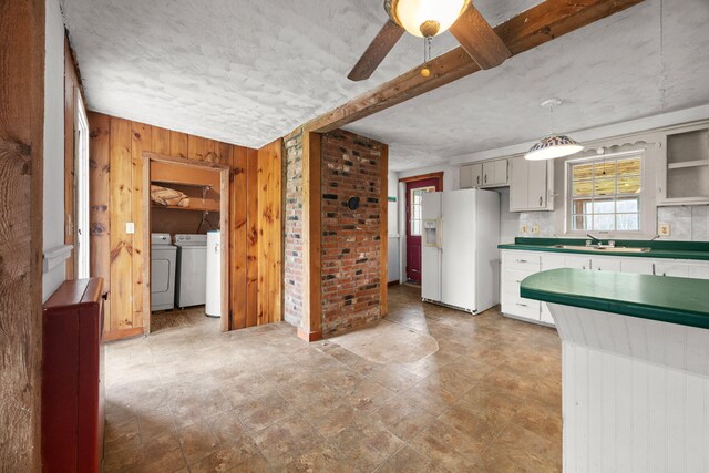 20 Crystal Spring Ln, Rome, ME 04963 - kitchen featuring white refrigerator with ice dispenser, washing machine and clothes dryer, wood walls, a sink, and ceiling fan