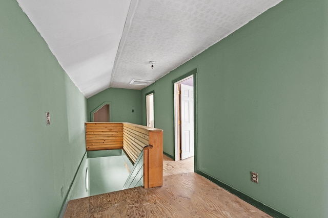 20 Crystal Spring Ln, Rome, ME 04963 - bonus room featuring wood finished floors, vaulted ceiling, baseboards, and a textured ceiling
