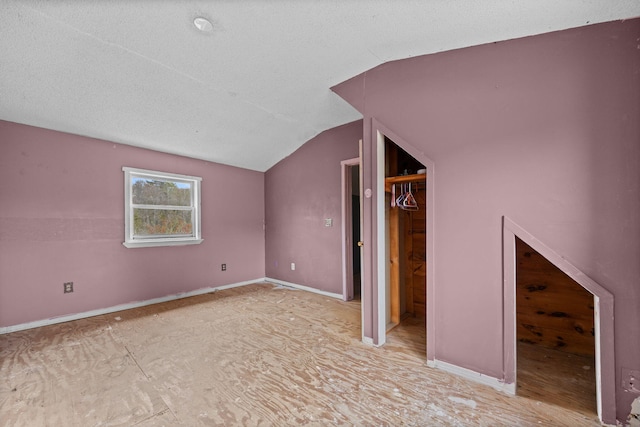 20 Crystal Spring Ln, Rome, ME 04963 - additional living space featuring vaulted ceiling, a textured ceiling, and baseboards