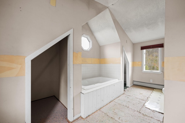 20 Crystal Spring Ln, Rome, ME 04963 - bathroom with baseboard heating, a bath, lofted ceiling, and a textured ceiling