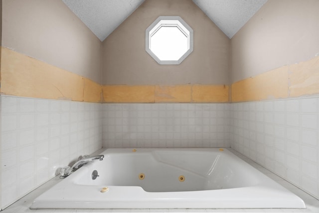 20 Crystal Spring Ln, Rome, ME 04963 - bathroom with tile walls, vaulted ceiling, and a tub with jets