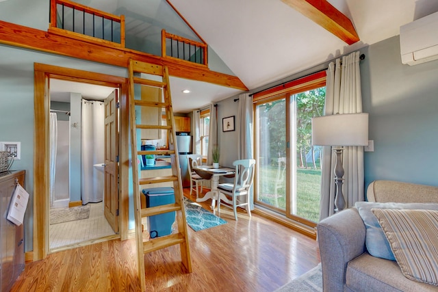 24 Ross Rd, Kennebunk, ME 04043 - living area featuring wood finished floors, an AC wall unit, and high vaulted ceiling