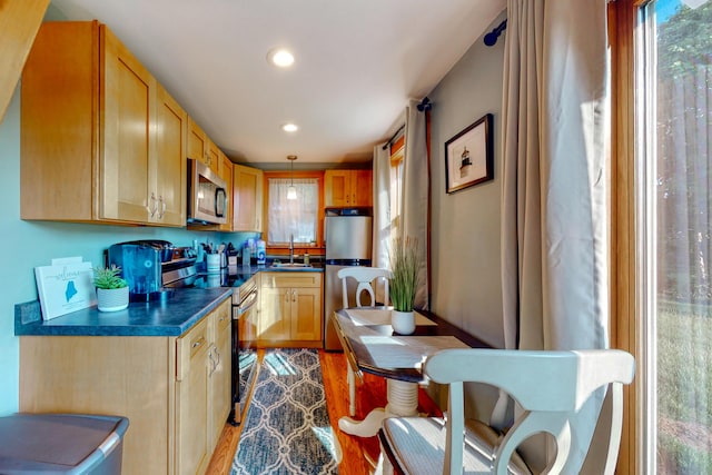 24 Ross Rd, Kennebunk, ME 04043 - kitchen with stainless steel appliances, dark countertops, light wood finished floors, a sink, and recessed lighting