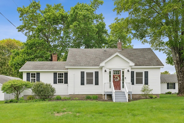 24 Ross Rd, Kennebunk, ME 04043 - view of front of property with a chimney, a front yard, and roof with shingles
