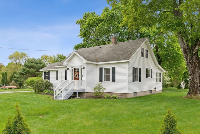 24 Ross Rd, Kennebunk, ME 04043 - view of front of property with a front yard, a chimney, and roof with shingles
