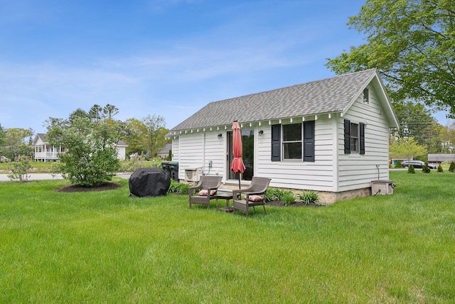 24 Ross Rd, Kennebunk, ME 04043 - back of house with roof with shingles and a yard