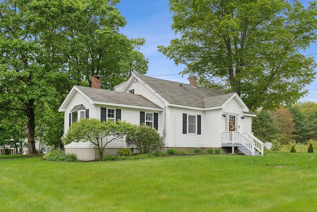 24 Ross Rd, Kennebunk, ME 04043 - view of front of home featuring a chimney, a front lawn, and roof with shingles