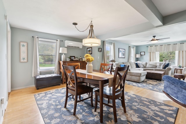 24 Ross Rd, Kennebunk, ME 04043 - dining area with an AC wall unit, wood finished floors, a ceiling fan, and baseboards
