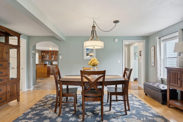 24 Ross Rd, Kennebunk, ME 04043 - dining room with arched walkways, light wood-style flooring, and baseboards