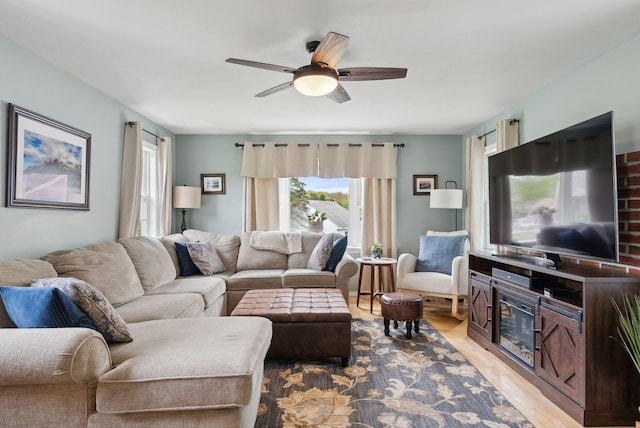 24 Ross Rd, Kennebunk, ME 04043 - living room with wood finished floors, a ceiling fan, and a fireplace
