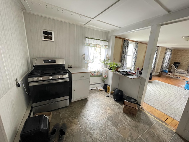 kitchen with gas stove, a baseboard radiator, and light countertops