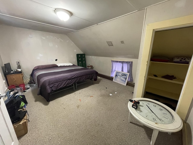 carpeted bedroom with lofted ceiling