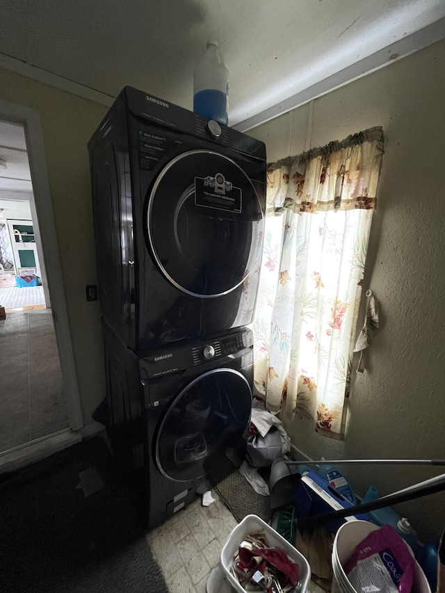 laundry area featuring stacked washer and clothes dryer
