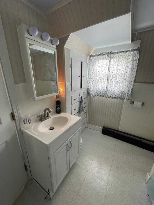 bathroom with vanity, tile patterned floors, vaulted ceiling, and wood walls